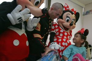Gunnery_Sgt._Tobin_Eckstine_along_with_Mickey_and_Minnie_Mouse_present_a_toy_to_a_girl_in_Meadowlands_Hospital
